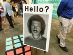 Sign with the word Hello? on it and a photo of Lionel Richie.