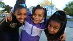 Three happy kids smiling.