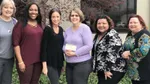 Six people from the St. Claire County Advocacy Center holding up a check.