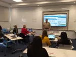 Ted in a classroom teaching several people how to use Collaborate.